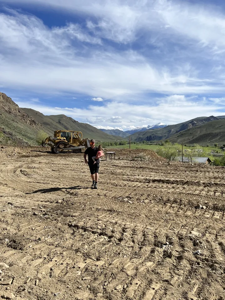 Peter and his daughter on the cleared Idaho building pad