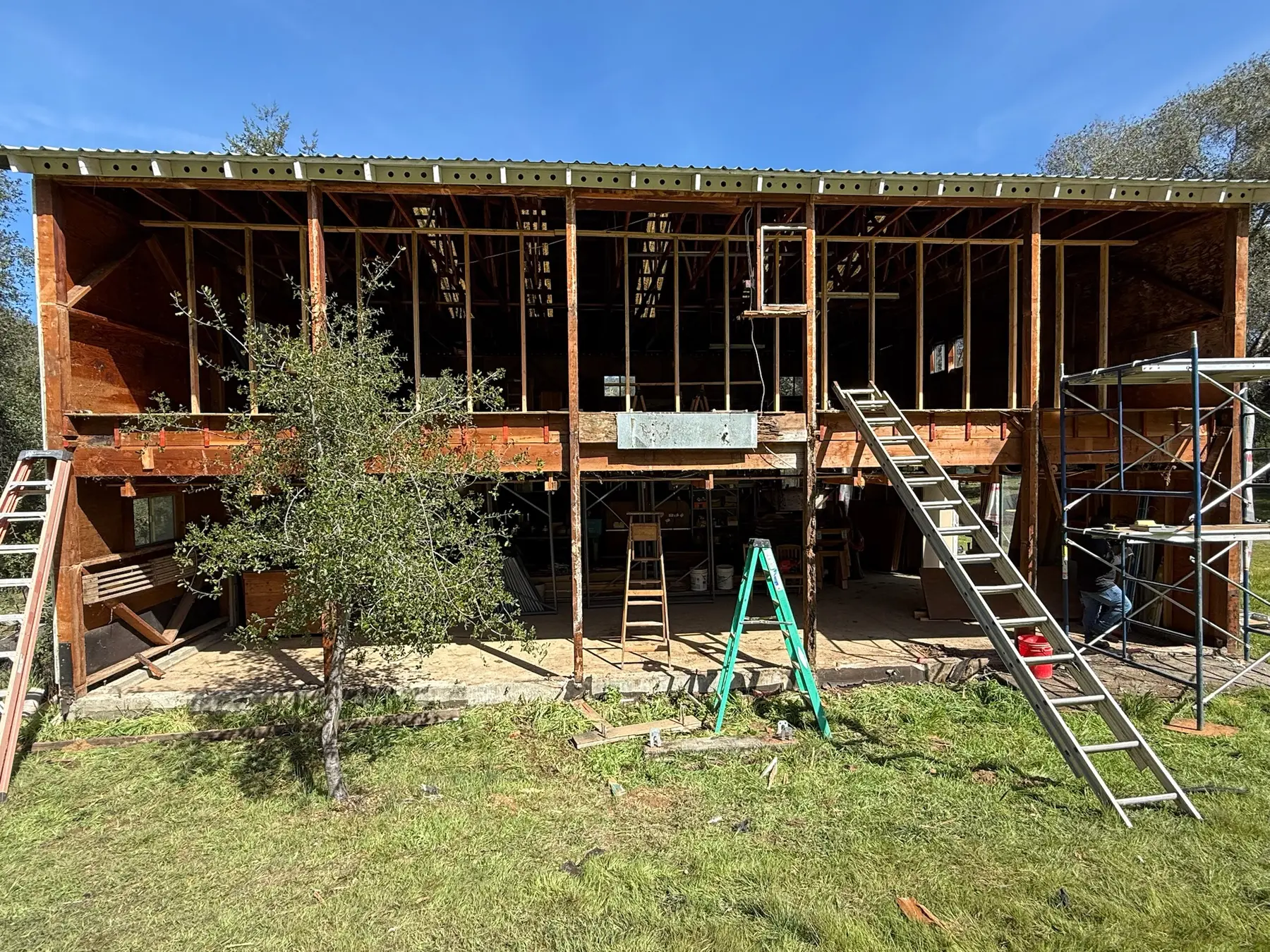 Two-story elevation fully stripped to exposed framing