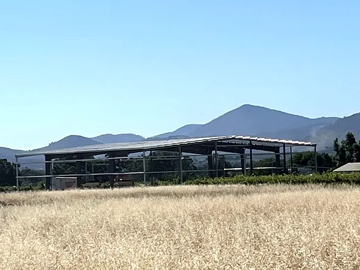 Lake County ranch steel building viewed across a field during construction