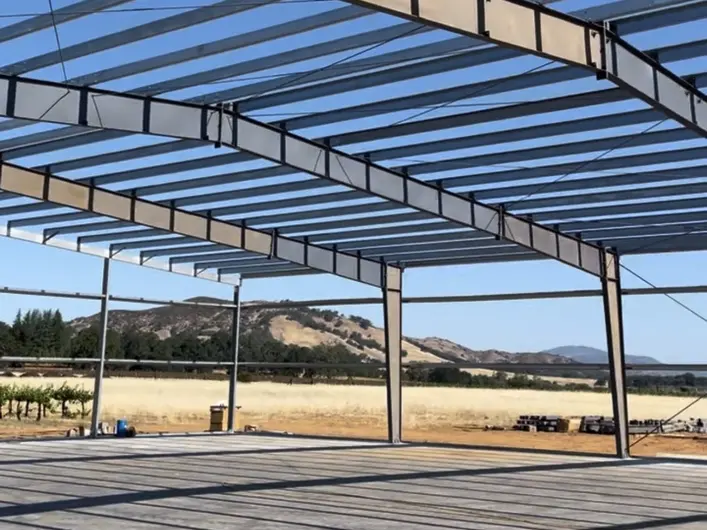 Open steel frame spanning the concrete slab at the Lake County ranch