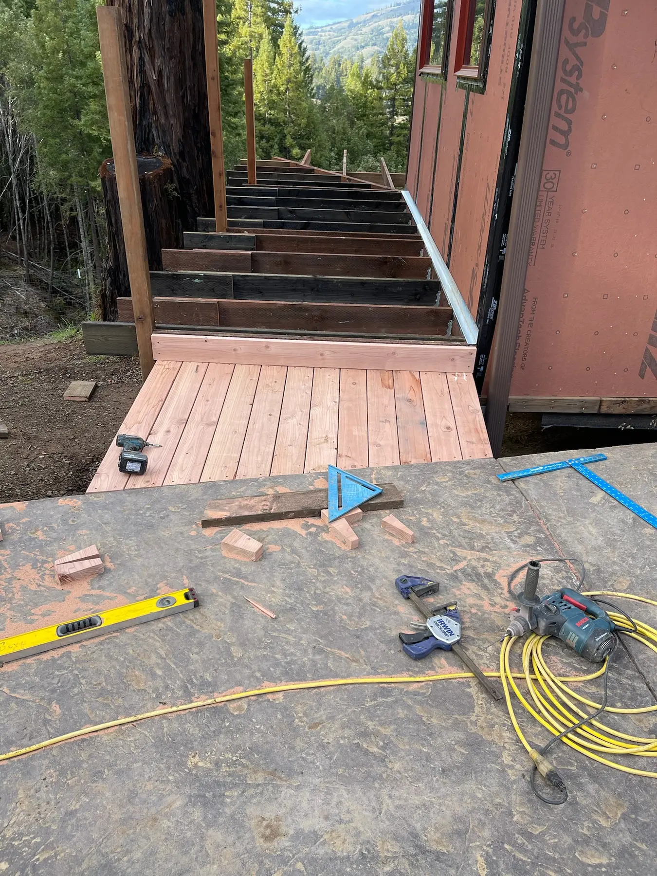 Deck framing on the slope beside the Old Mill residence